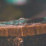 silver ring on brown wooden table
