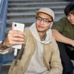 Two young men taking a selfie on stairs